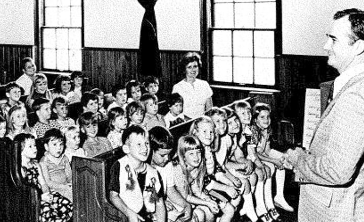The Rev. Henry Roberts leads students in a chapel service in the early years of Twin City Christian Academy.